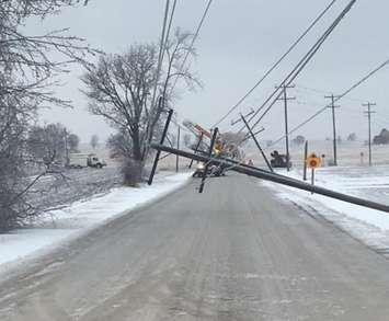 A broken hydro pole hangs over a roadway, April 15, 2018. Photo from Hydro One via Twitter.