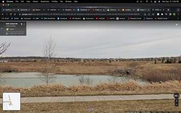 A stormwater pond on Jackson Road near Evans Boulevard in London, Ontario. Screen capture via Google Street View. 