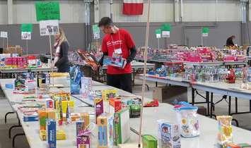 A volunteer packs Christmas hampers for the Salvation Army. File photo taken prior to the COVID-19 pandemic. (Photo by Miranda Chant, Blackburn News)