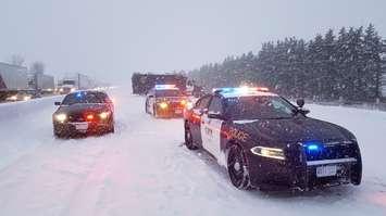 Police conduct an investigation following a fatal crash on Highway 401 in Oxford County, February 13, 2019. (Photo courtesy of the OPP)