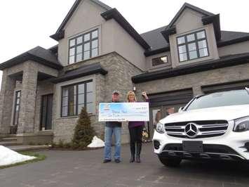 Brenda and John Held stand in front of the Dream Lottery home on January 18, 2017. Photo by Miranda Chant, BlackburnNews.com