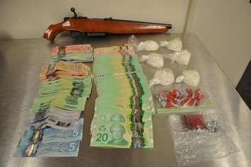 Photo of the drugs, cash and gun seized in a police raid at a Pond Mills Rd. home. Photo courtesy of London Police. 