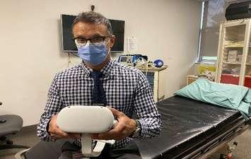 Dr. Naveen Poonai holds a virtual reality headset. Photo courtesy of Lawson Health Research Institute. 