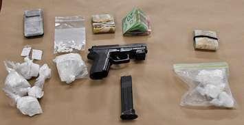 A replica gun, cocaine, Percocet pills, and cash seized during raids by London police on February 6, 2019. Photo courtesy of London police.