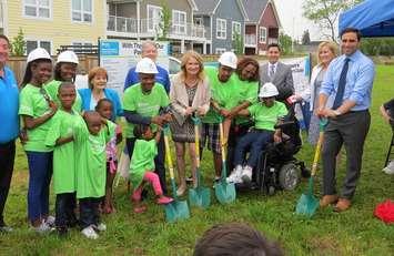 The Cooper and Kassa families, joined by London MPs Peter Fragiskatos, Kate Young, and Irene Mathyssen, break ground on Habitat for Humanity homes on Forbes St., July 10, 2017. (Photo by Miranda Chant, Blackburn News)