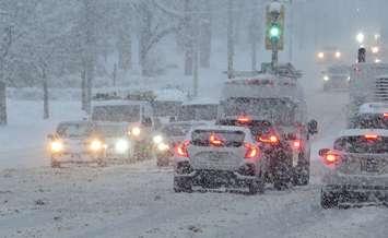 Vehicles travel on a snow covered road. (File photo by Miranda Chant, Blackburn Media)