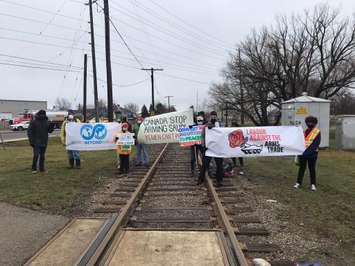 A group of activists gathers on the CN railway near General Dynamics to protest arms exports to Saudi Arabia. March 26, 2021. (Photo supplied by Labour Against The Arms Trade Canada) 