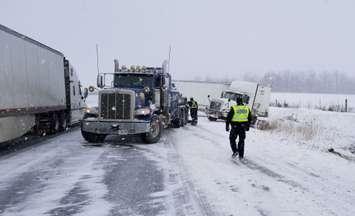 OPP officer at the scene of a tractor trailer collision on Hwy. 402 at Centre Rd. January 30, 2018. Photo courtesy of the OPP.