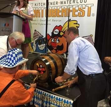 Mayor Matt Brown taps a keg at the Oktoberfest London announcement. July 15, 2015. Photo by Ashton Patis. 