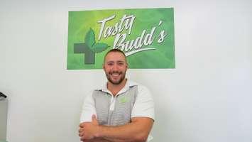 VP of Tasty Budds London, Tim Balogh, stands in front of the dispensary's sign at their new location on Wharncliffe Rd. (Photo by Samuel Gallant)