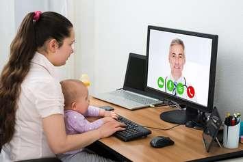 A woman has a virtual visit with a doctor. (File photo courtesy of © Can Stock Photo / AndreyPopov)