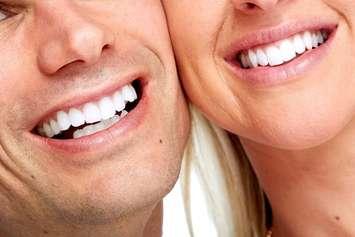 Two people smiling. File photo courtesy of © Can Stock Photo / Kurhan