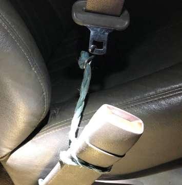 Twine and a metal hook were found to be holding the seatbelt together in a vehicle pulled over in Norfolk County, October 11, 2021. Photo courtesy of OPP.