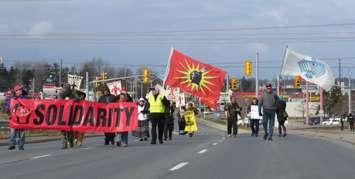 Dozens of people march across the Wellington Rd. overpass at Hwy. 401 in support of those protecting the Dakota Access pipeline in North Dakota, December 5, 2016. (Photo by Miranda Chant, Blackburn News.)