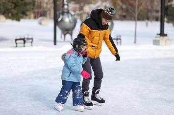 A father and child skate on the outdoor rink in Victoria Park. File photo courtesy of the City of London. 