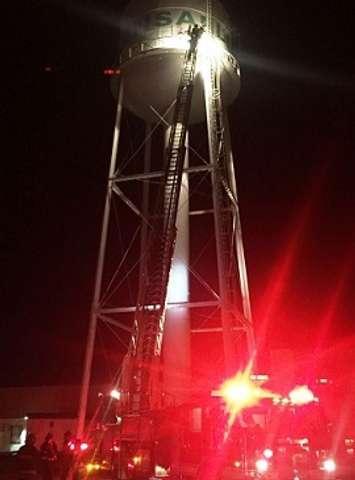 Police and firefighters rescue three men from atop a water tower in Exeter. Photo courtesy of Huron OPP.