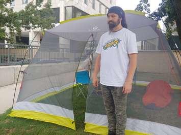 Activist Dan Oudshoorn stands outside of his tent at London City Hall. He began a hunger strike on August 2nd, 2022. (Craig Needles/Blackburn Media)