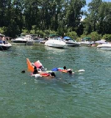 People in the water after their boat capsized at Pottahawk, July 14, 2019. Photo courtesy of Norfolk OPP.