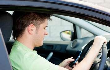 Distracted driving file photo courtesy of © Can Stock Photo Inc. / 4774344sean