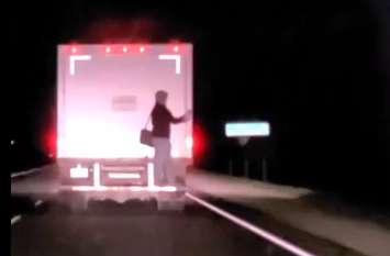 A person clings to the back of a truck travelling on Highway 24 in Norfolk County. Image courtesy of Norfolk OPP. 
