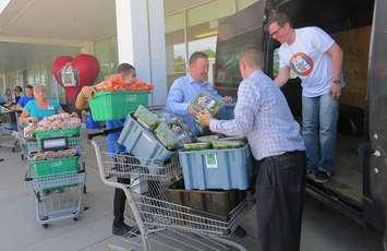 Real Canadian Superstore employees load produce and baked goods into the London Food Bank donation van outside of the store at 825 Oxford St., May 30, 2018. (Photo by Miranda Chant, Blackburn News)