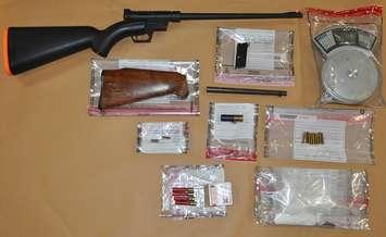 A rifle, drugs and other items seized during a raid at two London homes, April 14, 2021. Photo courtesy of London police. 