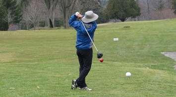 A golfer tees off at Thames Valley Golf Course. (File photo by Miranda Chant, Blackburn News)
