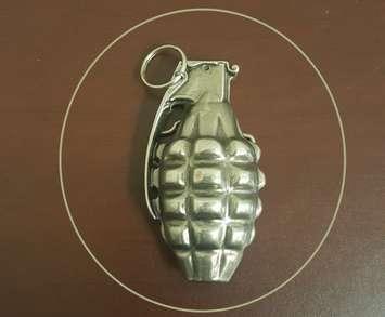 Photo of a belt buckle in the shape of hand grenade provided by London police. 