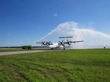 A de Havilland Dash 7 aircraft being donated to Fanshawe College's aviation school receives a water cannon salute upon landing at the London International Airport, June 19, 2017. (Photo by Miranda Chant, Blackburn News)