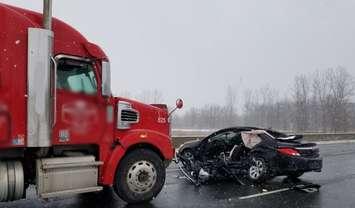 A collision between a car and a transport truck on the Highway 401 near London. 26 January 2021. (Photo by Middlesex OPP)