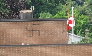 A swastika was spray-painted on the exterior of a building. August 2018. (Photo courtesy of Peter Tangredi)
