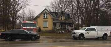 Fire officials investigating a house fire at 22706 Adelaide Road, Mount Brydges, January 10, 2020. Photo courtesy of Strathroy Caradoc police.