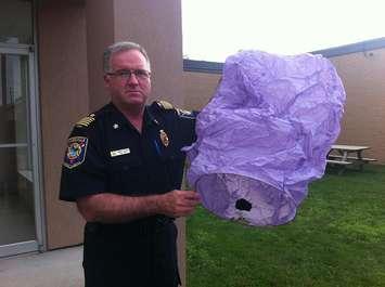 Kingsville Fire Chief Bob Kissner holds a used flying lantern, outside of Kingsville's town hall building, July 22, 2013.