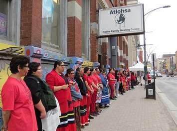 Dozens of Indigenous women stand in silence outside of Atlohsa Family Healing Services at 343 Richmond St., May 6, 2019. (Photo by Miranda Chant, Blackburn News) 