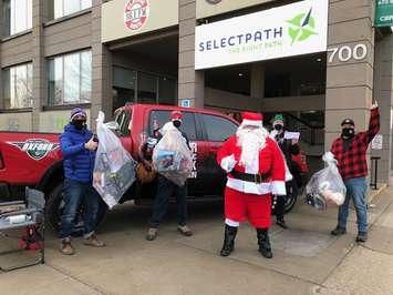 Blair and RV of Classic Rock Mornings, along with Santa himself, collect toys for the Salvation Army's Christmas hamper program at the corner of Richmond and Piccadilly streets, December 11, 2020. (Photo courtesy of Blair and RV)