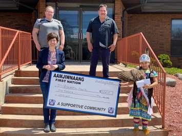 Foundation Executive Director Kathy Alexander accepts donation from (starting top left) Heather Robertson, Registered Nurse, Chief Chris Plain, and Princess Lily. (Photo courtesy of BWHF via Facebook)