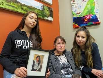Cindy Gladue's daughter Cheyanne, mother Donna, and daughter Brandy hold a photo of the murdered Edmonton woman, October 20, 2017. (Photo by Miranda Chant, Blackburn News)