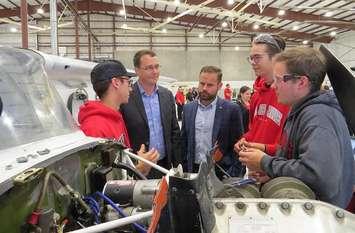 Ontario Minister of Labour Monte MacNaughton and Parliamentary Assistant for the Ministry of Training, College and Universities David Piccini (centre)speak with three of Fanshawe College's aviation students during the announcement of the school's new aviation training program, September 13, 2019. (Photo by Miranda Chant, Blackburn News)