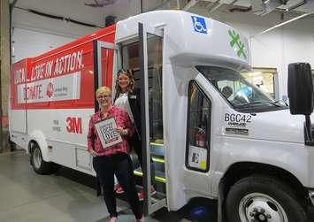 United Way Elgin Middlesex CEO Kelly Ziegner and 2018 Campaign Chair Kyla Woodcock show off the new Local Love in Action bus, September 20, 2018. (Photo by Miranda Chant, Blackburn News)