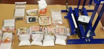 A quantity of drugs, cash and a fentanyl press seized by London police during a raid in the city on January 3, 2020. Photo courtesy of London police.