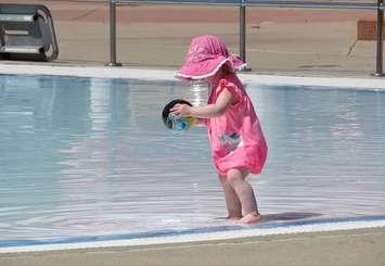 A little girl plays in the water at the Thames pool in London. (File photo by Miranda Chant, Blackburn Media)