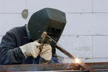 Welder worker welding metal.  © Can Stock Photo / Alekss