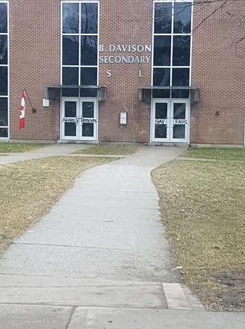 Police are investigating after homophobic and Islamophobic slurs were spray painted on the doors to B. Davison Secondary School. (Photo courtesy of M El Saad via Facebook)