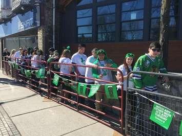 Londoners dressed in green wait in line outside a downtown bar. Photo by Ashton Patis. 