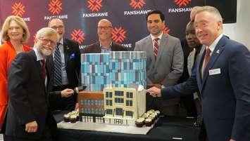 Fanshawe College President Peter Devlin (right) and other politicians and dignitaries cut a cake shaped like the college's new building at 130 Dundas St., at its grand open, September 14, 2018. (Photo by Miranda Chant, Blackburn News)     
