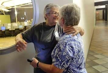 Lupe Garcia, left, hugs her partner Cindy Stocking, right, at the Travis County building after hearing the Supreme Court ruling that grants same-sex couples the right to marry nationwide, Friday, June 26, 2015, in Austin, Texas. (AP Photo/Eric Gay)