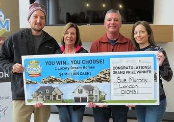 Sue Murphy and Dennis Reed (centre) and their two kids Jon Sweitzer and Erika Mercer hold the grand prize winner cheque for the fall edition of the Dream Lottery, December 5, 2019. (Photo by Miranda Chant, Blackburn News)