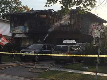 Firefighters spray hotspots after a house fire at 204 Millbank Dr., September 10, 2019. (Photo by Scott Kitching, Blackburn News.)