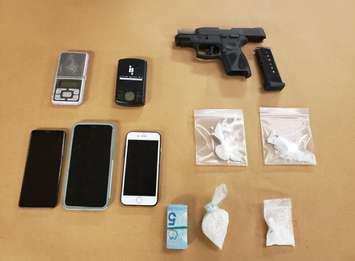 A handgun and various drugs seized by London police during the search of a home on Briscoe Street East, January 28, 2021. Photo courtesy of London police.