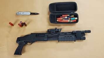 A pump-action shotgun, a switchblade and ammunition seized during a raid at a home on Andover Dr., March 3, 2021. Photo courtesy of London police. 